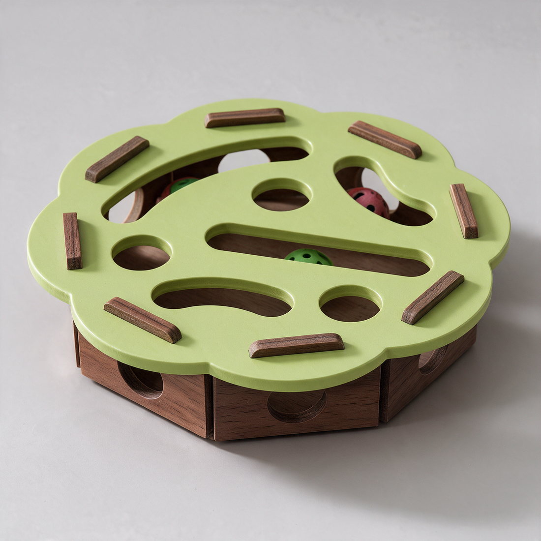 Close-up of a belled ball in the PuzzleFurr wooden track, held so it cannot be lost